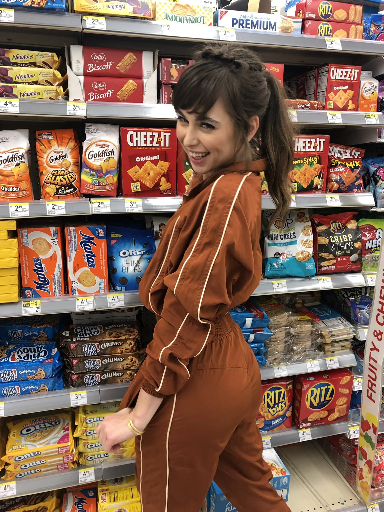 Riley (@rileyreidx3) Onlyfans model enjoying buying at convenient store wearing a brown overall outfit
